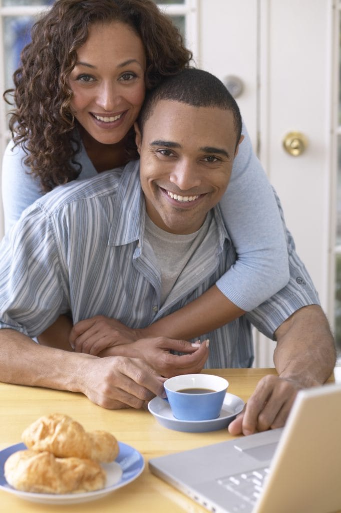 Couple at Dining Table with Laptop